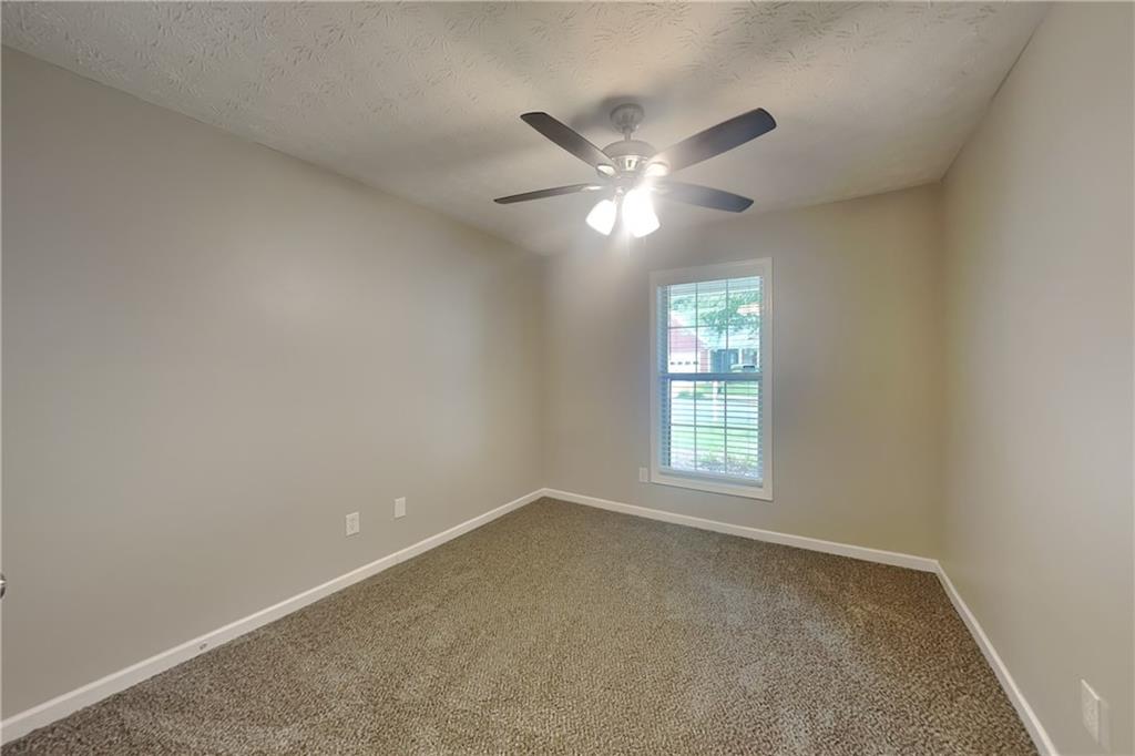3318 Freedom Landing Northwest Kennesaw, GA 30144 - Photo 12 of 15 an empty room with windows and fan