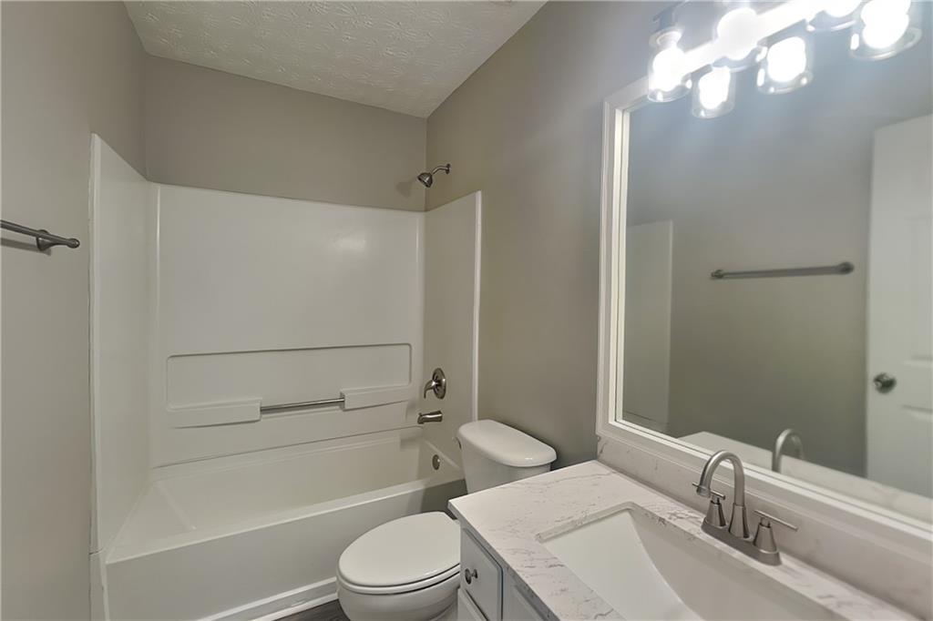 3318 Freedom Landing Northwest Kennesaw, GA 30144 - Photo 13 of 15 a bathroom with a sink a toilet and shower