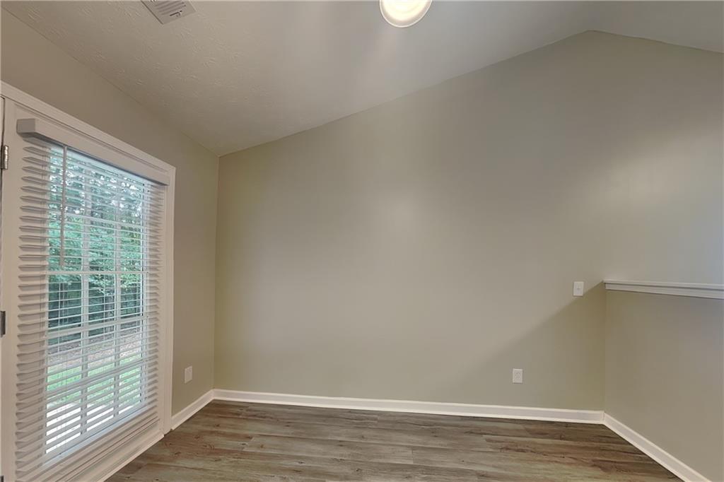 3318 Freedom Landing Northwest Kennesaw, GA 30144 - Photo 5 of 15 a view of an empty room with wooden floor and a window