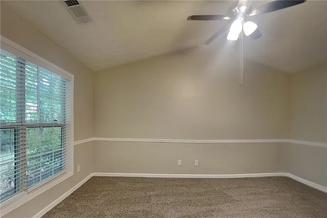 an empty room with windows and outdoor view