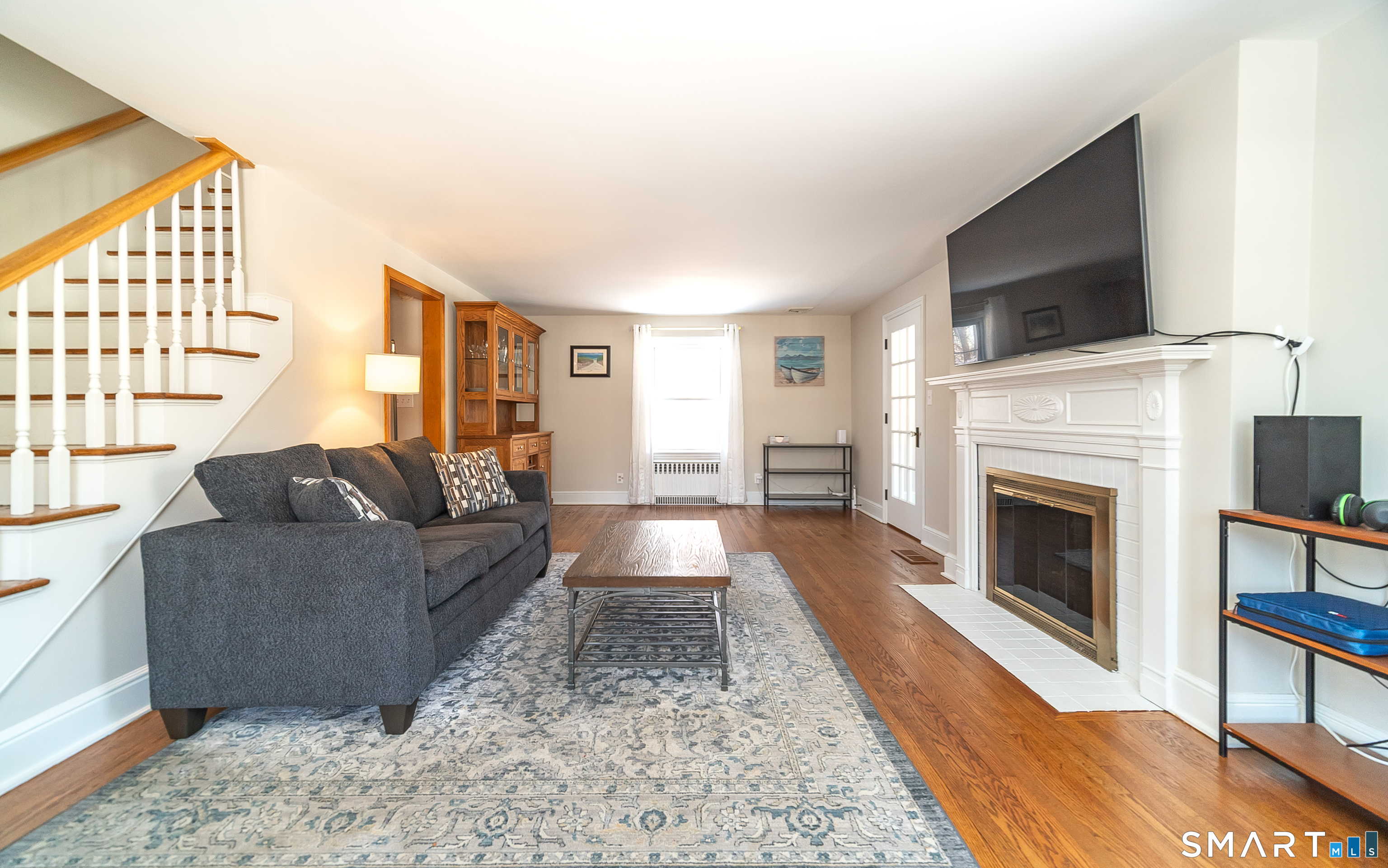 45 Craig Avenue Southington, CT 06489 - Photo 12 of 40 a living room with furniture a flat screen tv and a fireplace