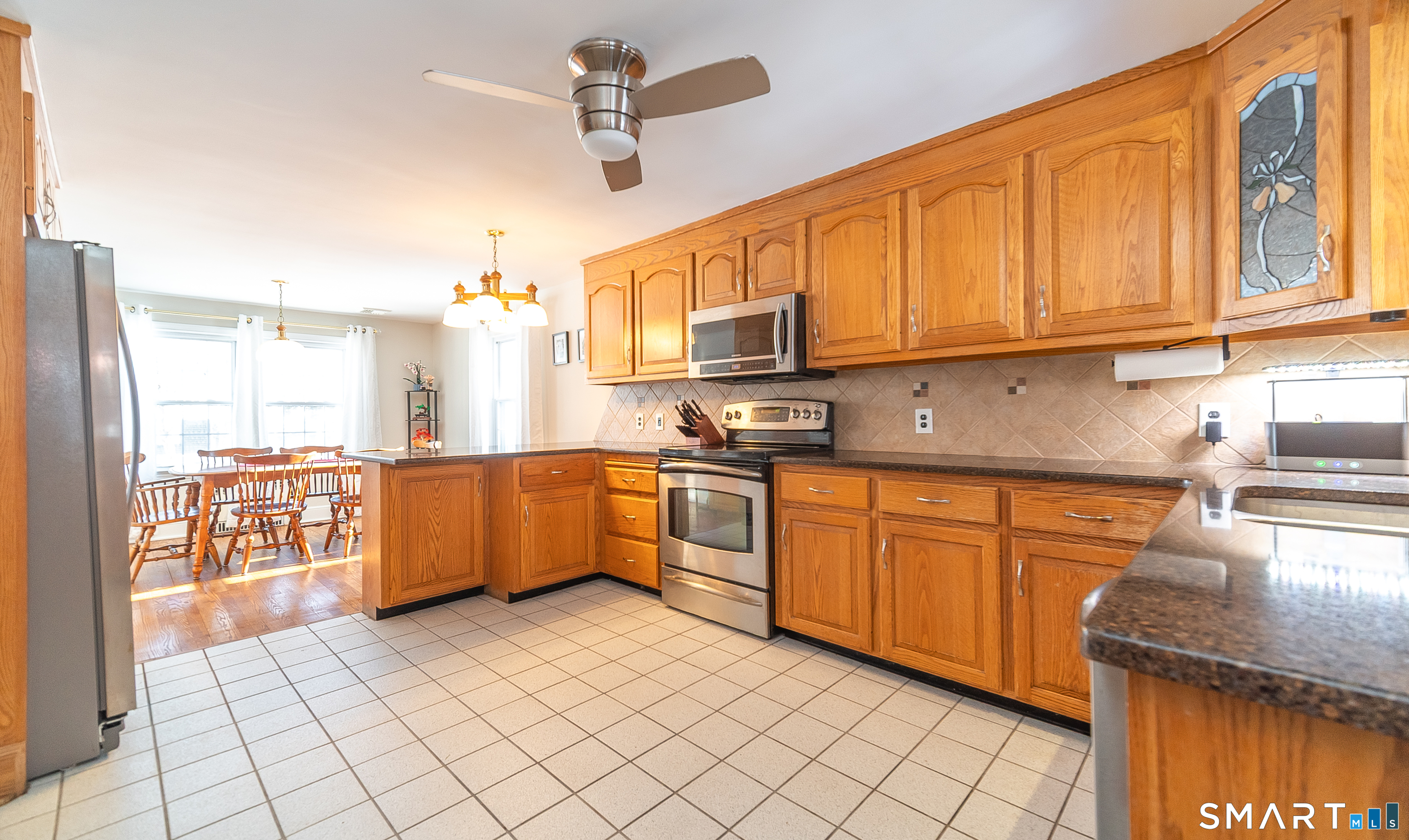 45 Craig Avenue Southington, CT 06489 - Photo 19 of 40 a kitchen with stainless steel appliances granite countertop a stove a sink dishwasher and a refrigerator with wooden cabinets