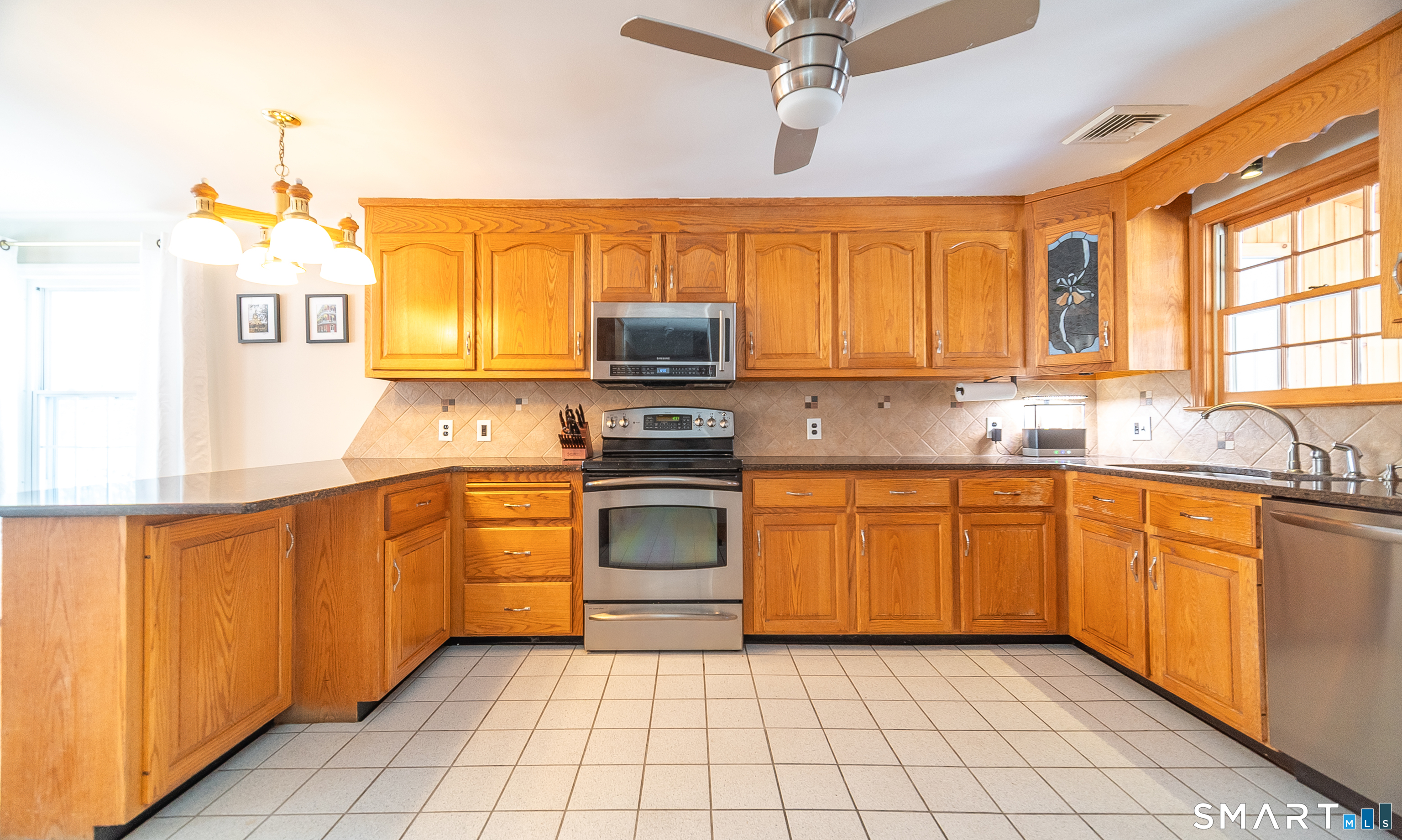45 Craig Avenue Southington, CT 06489 - Photo 21 of 40 a kitchen with stainless steel appliances granite countertop a stove sink and microwave