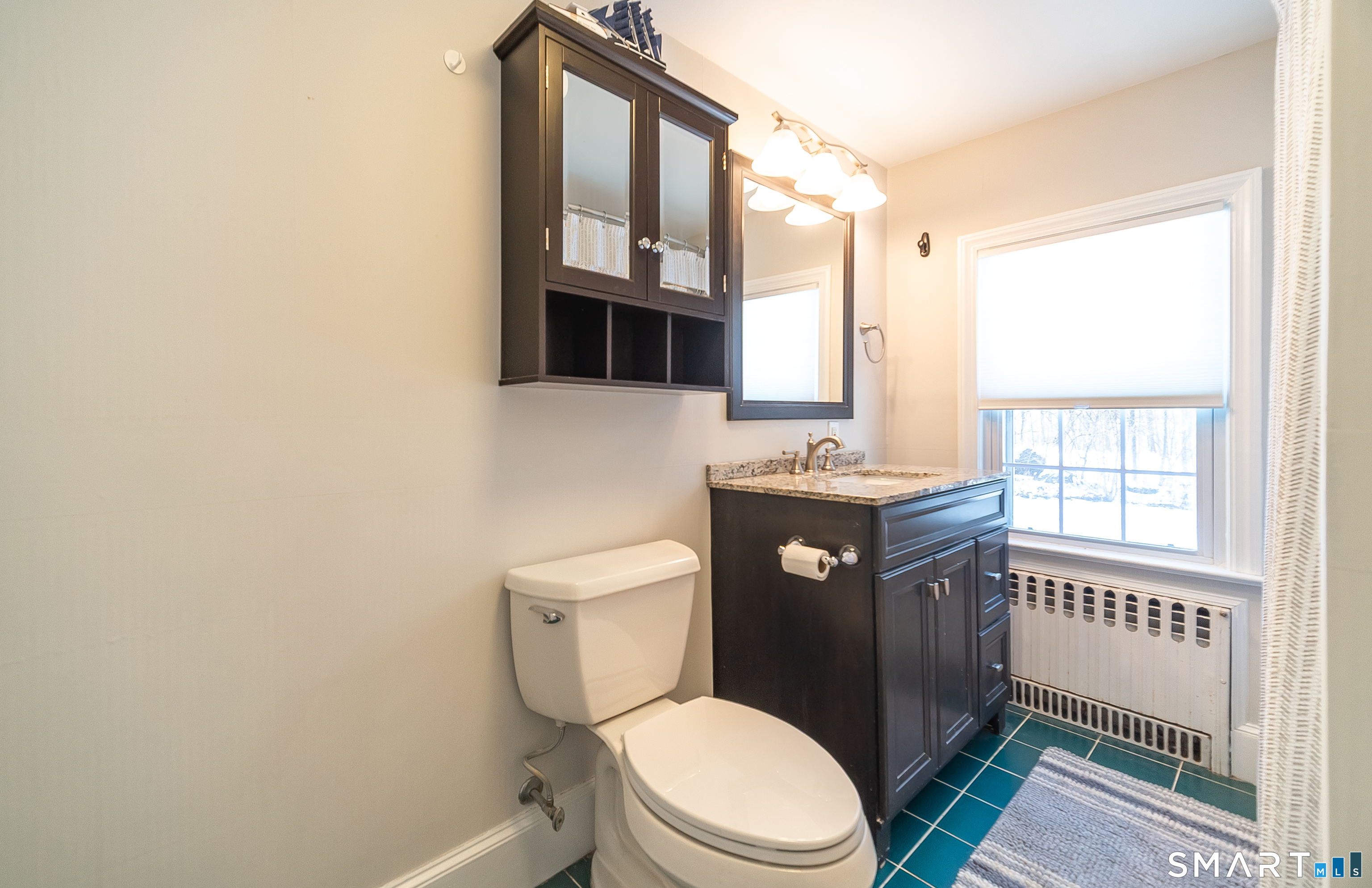45 Craig Avenue Southington, CT 06489 - Photo 31 of 40 a bathroom with a toilet sink vanity and mirror