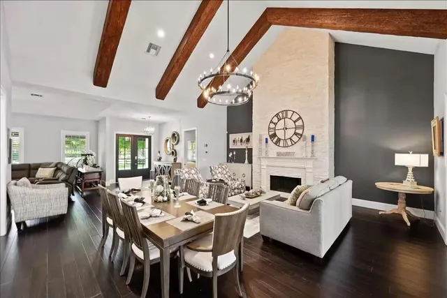 a living room with fireplace furniture and a wooden floor