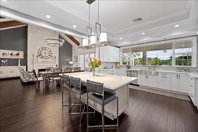 a kitchen with lots of counter top space and painting on the wall