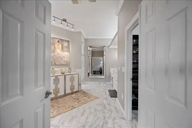 a bathroom with a sink a granite counter top and a toilet