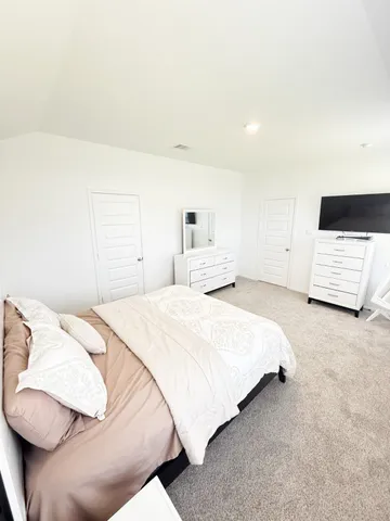 a bedroom with a bed and a couch