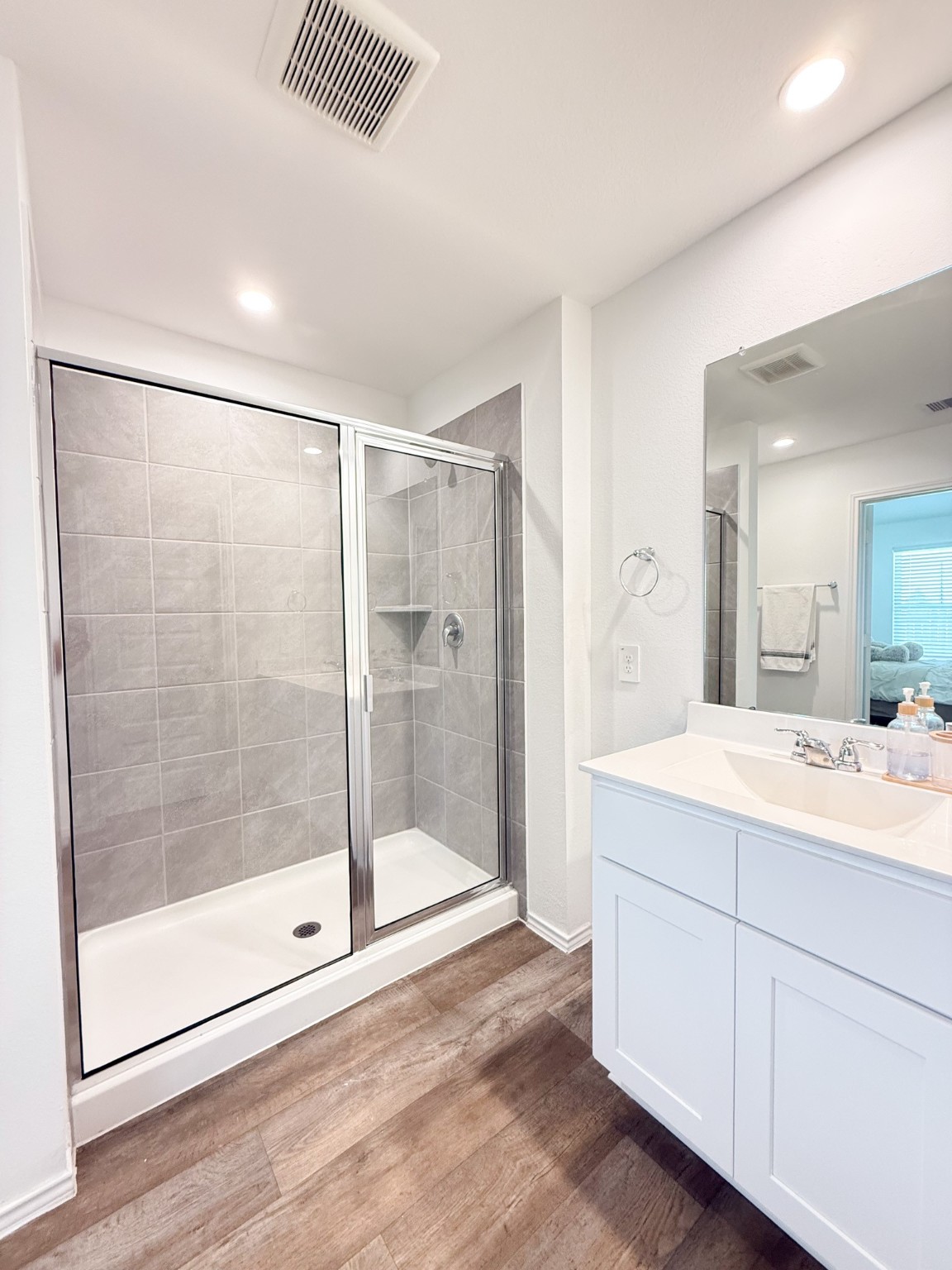 3611 Ashford Grove Fulshear, TX 77441 - Photo 14 of 20 a bathroom with a shower sink and mirror