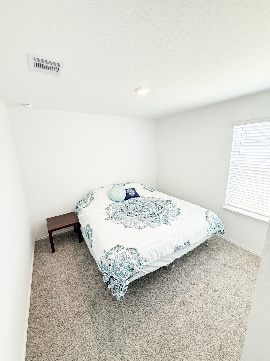 3611 Ashford Grove Fulshear, TX 77441 - Photo 19 of 20 a bed sitting in a bedroom next to a window