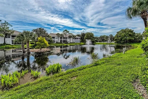 a view of a lake with houses in the back