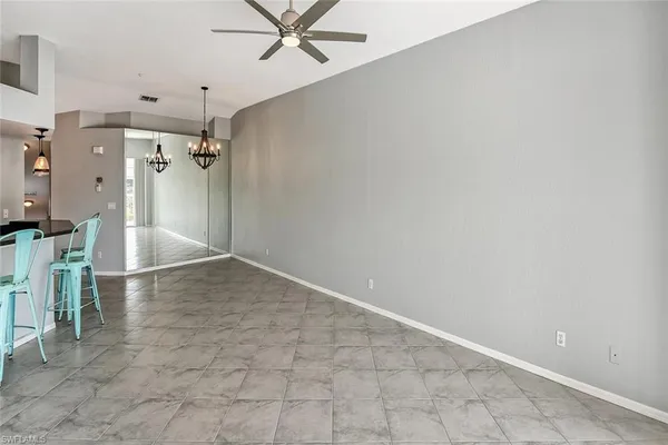 a view of a livingroom with a ceiling fan and entryway