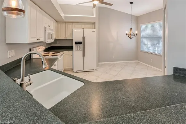 a kitchen with a sink a stove and cabinets