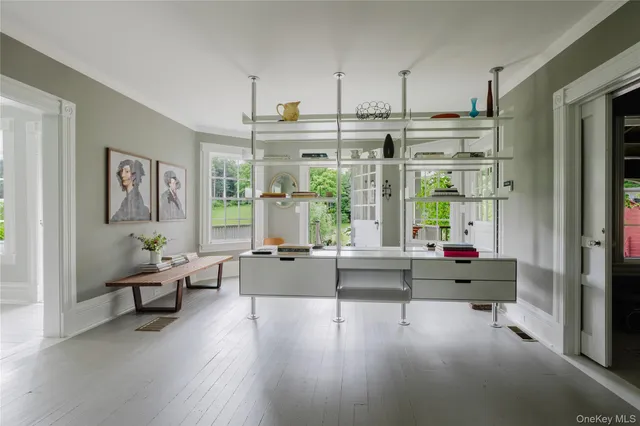 a living room with furniture and large windows