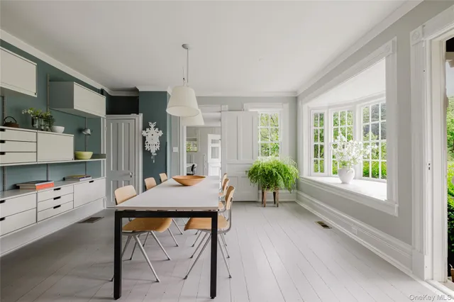 a very nice looking room with a large window and furniture