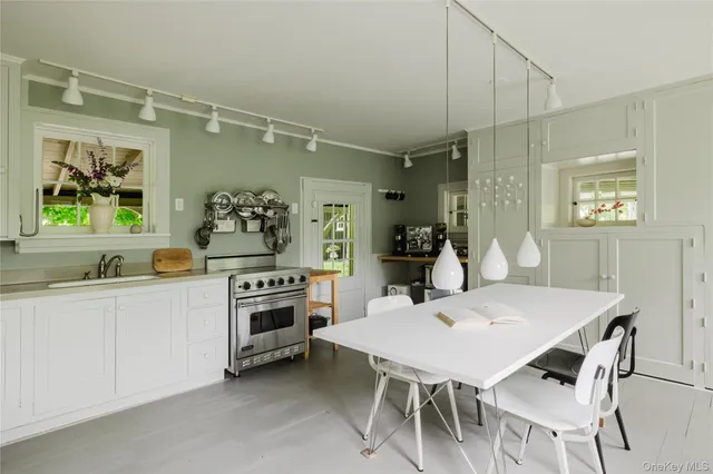 a kitchen with a stove a table and chairs