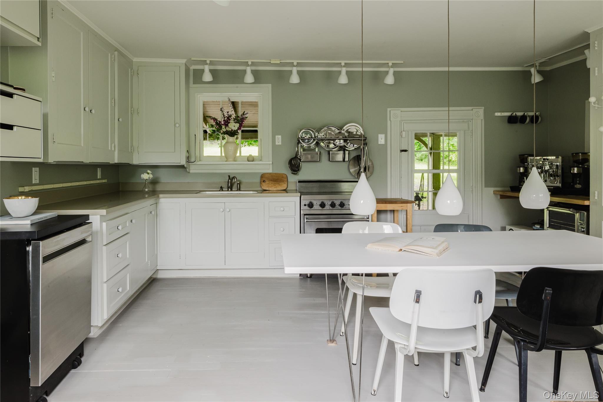 88 Mac Brown Road Claverack, NY 12513 - Photo 20 of 49 a kitchen with stainless steel appliances a white table chairs and a refrigerator