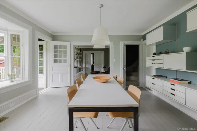 a dining room with a table and chairs