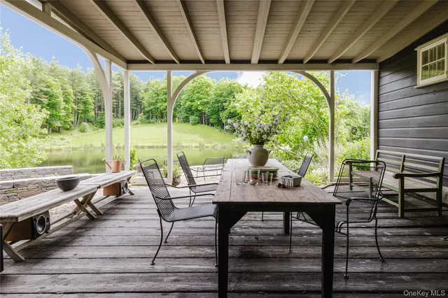 a view of a patio with table and chairs and wooden floor