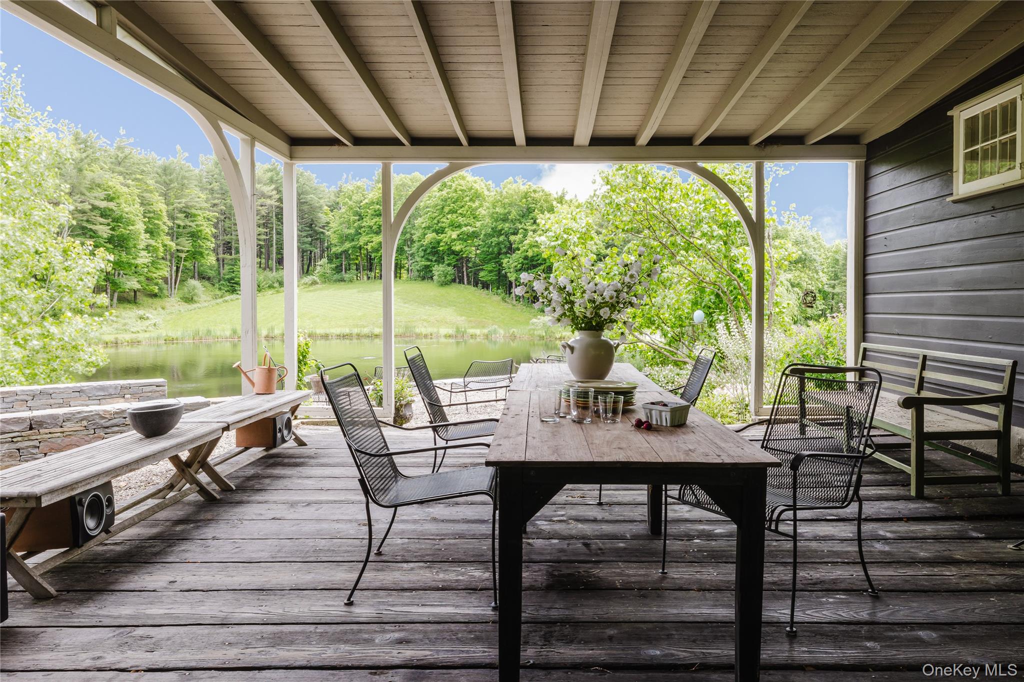 88 Mac Brown Road Claverack, NY 12513 - Photo 22 of 49 a view of a patio with table and chairs and wooden floor