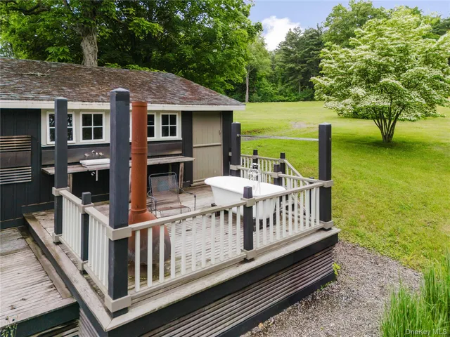 a view of a house with backyard and deck