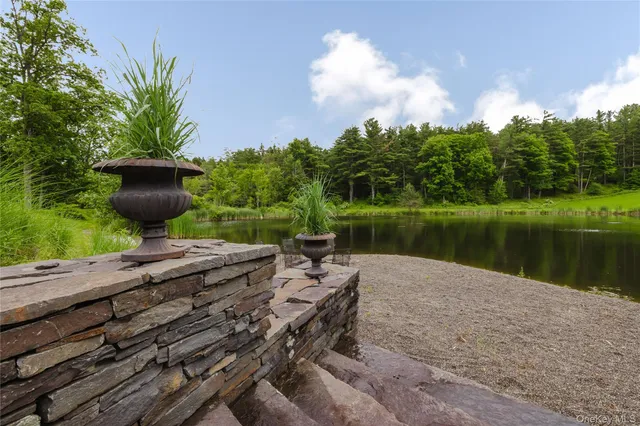 a wooden bench sitting next to a lake