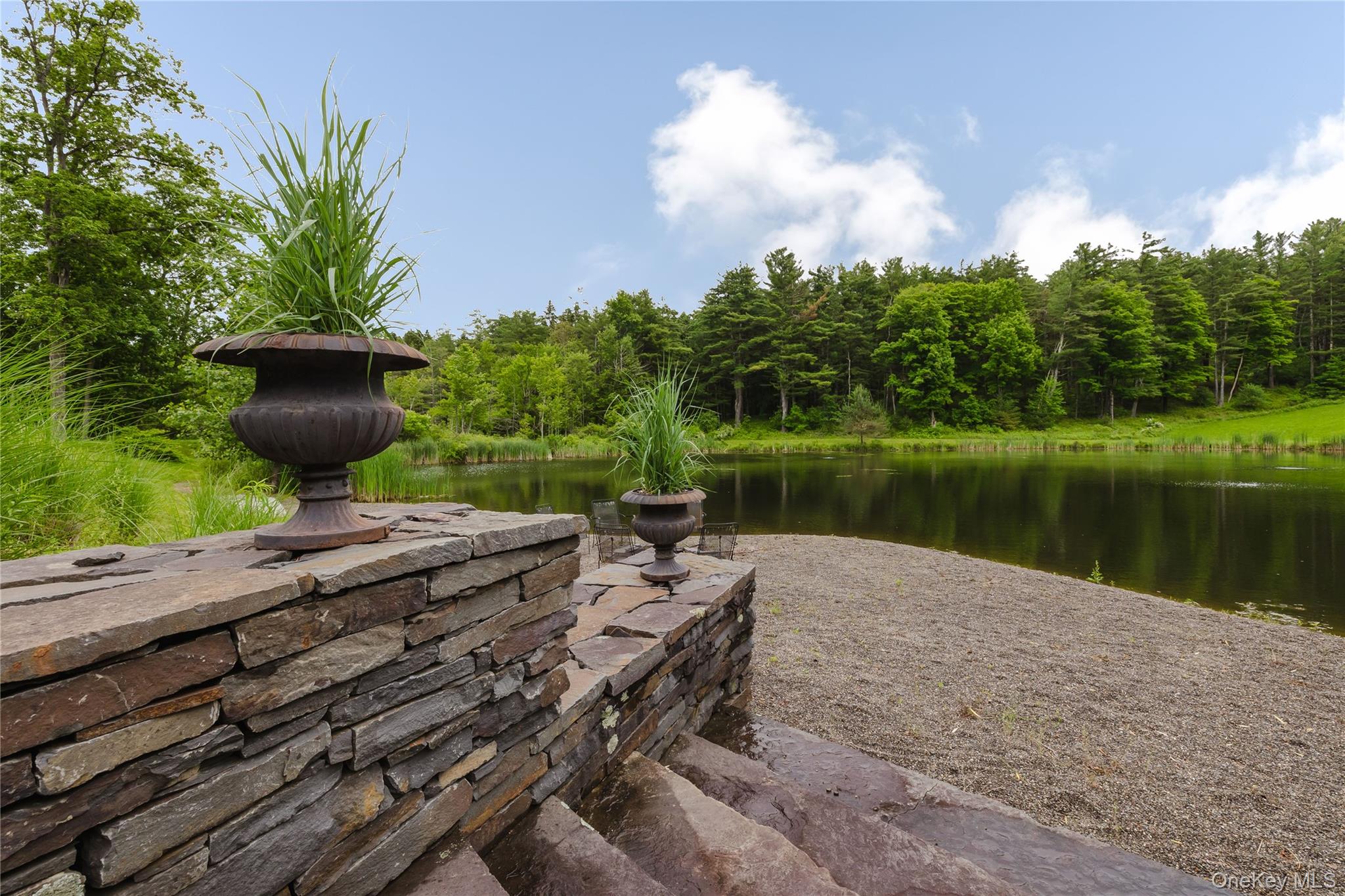 88 Mac Brown Road Claverack, NY 12513 - Photo 7 of 49 a wooden bench sitting next to a lake