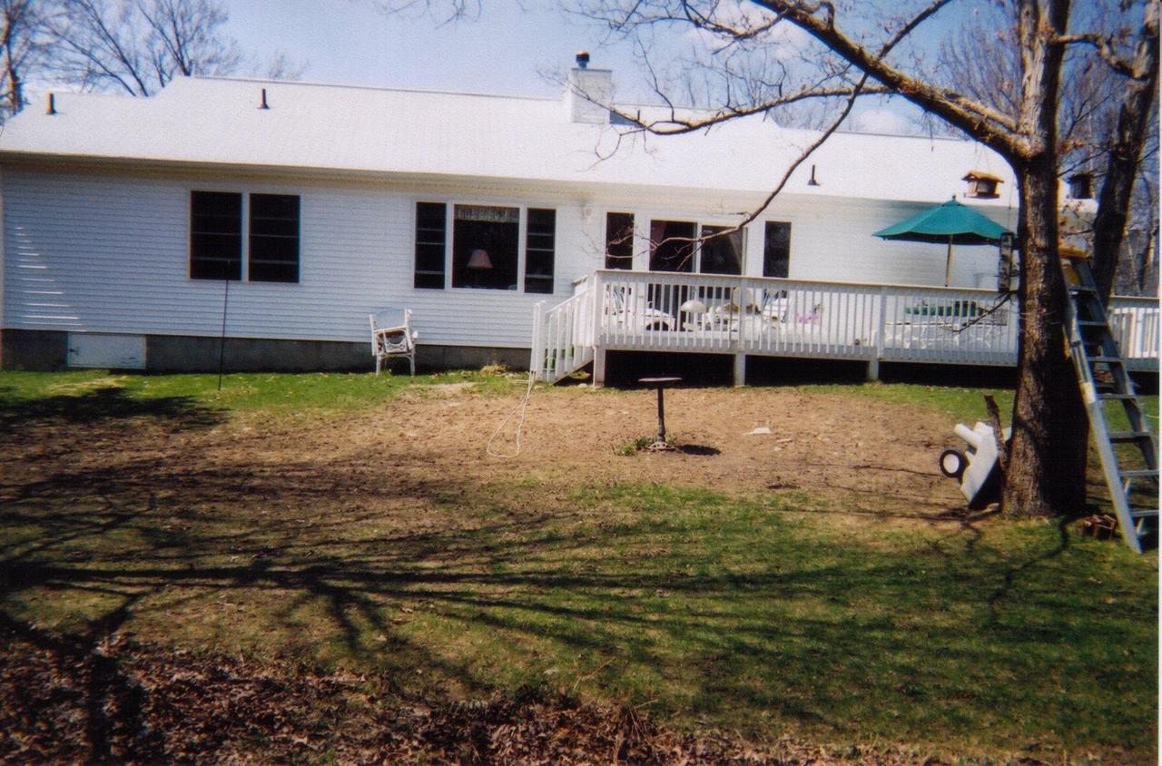 5524 Granite Road Long Pond, PA 18334 - Photo 1 of 5 a view of a house with backyard water fountain and a fire pit