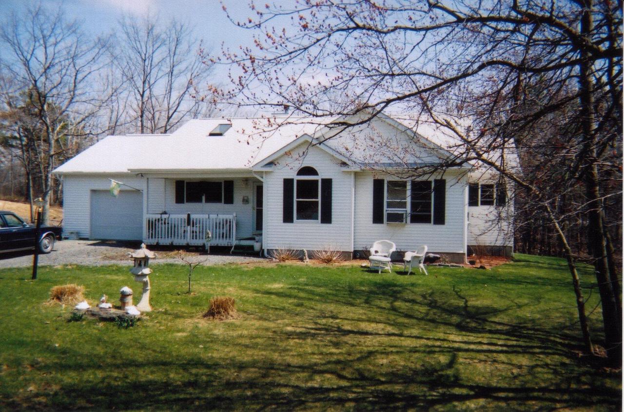 5524 Granite Road Long Pond, PA 18334 - Photo 3 of 5 a front view of a house with a yard