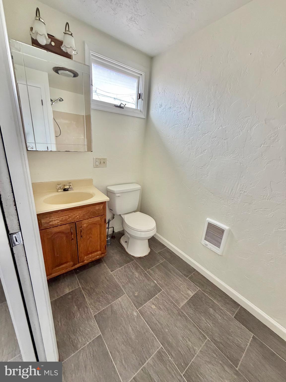 1211 West Poplar Street York, PA 17404 - Photo 17 of 38 a bathroom with a white toilet and a shower