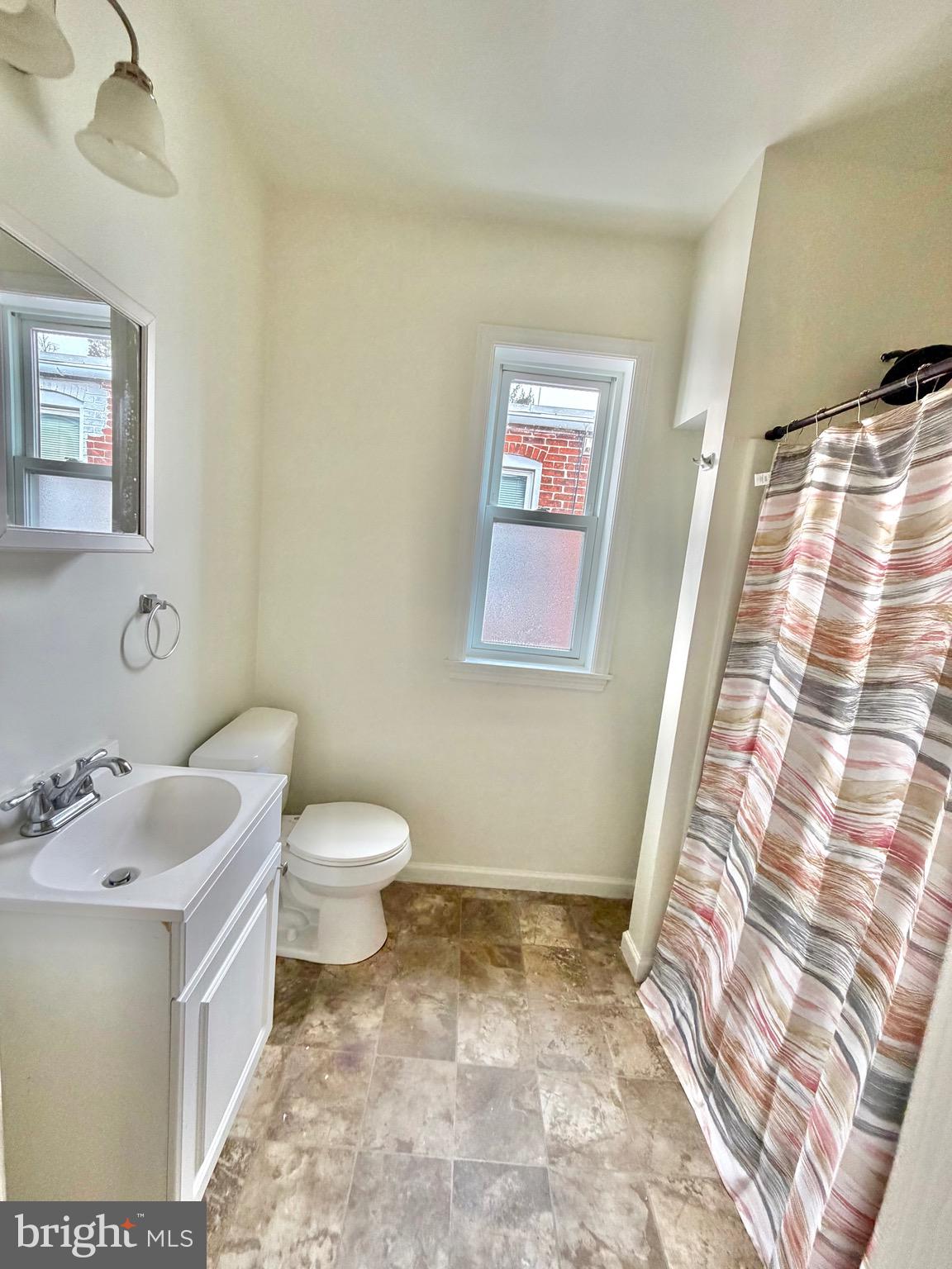 1211 West Poplar Street York, PA 17404 - Photo 20 of 38 a bathroom with a sink a toilet and a mirror