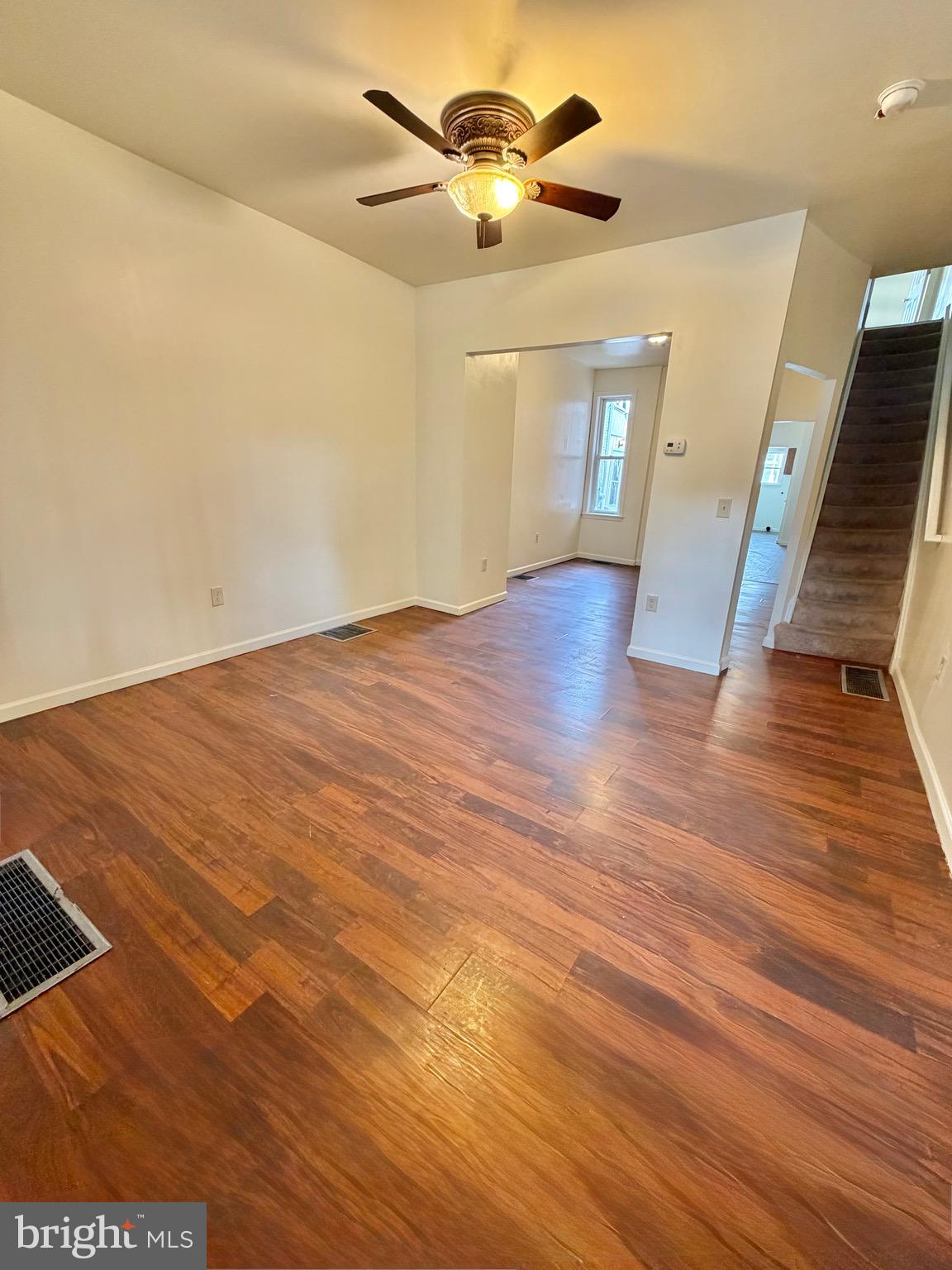 1211 West Poplar Street York, PA 17404 - Photo 2 of 38 a view of an empty room with wooden floor and a ceiling fan