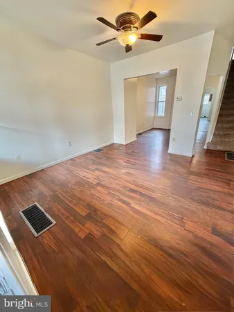 wooden floor in an empty room with a window