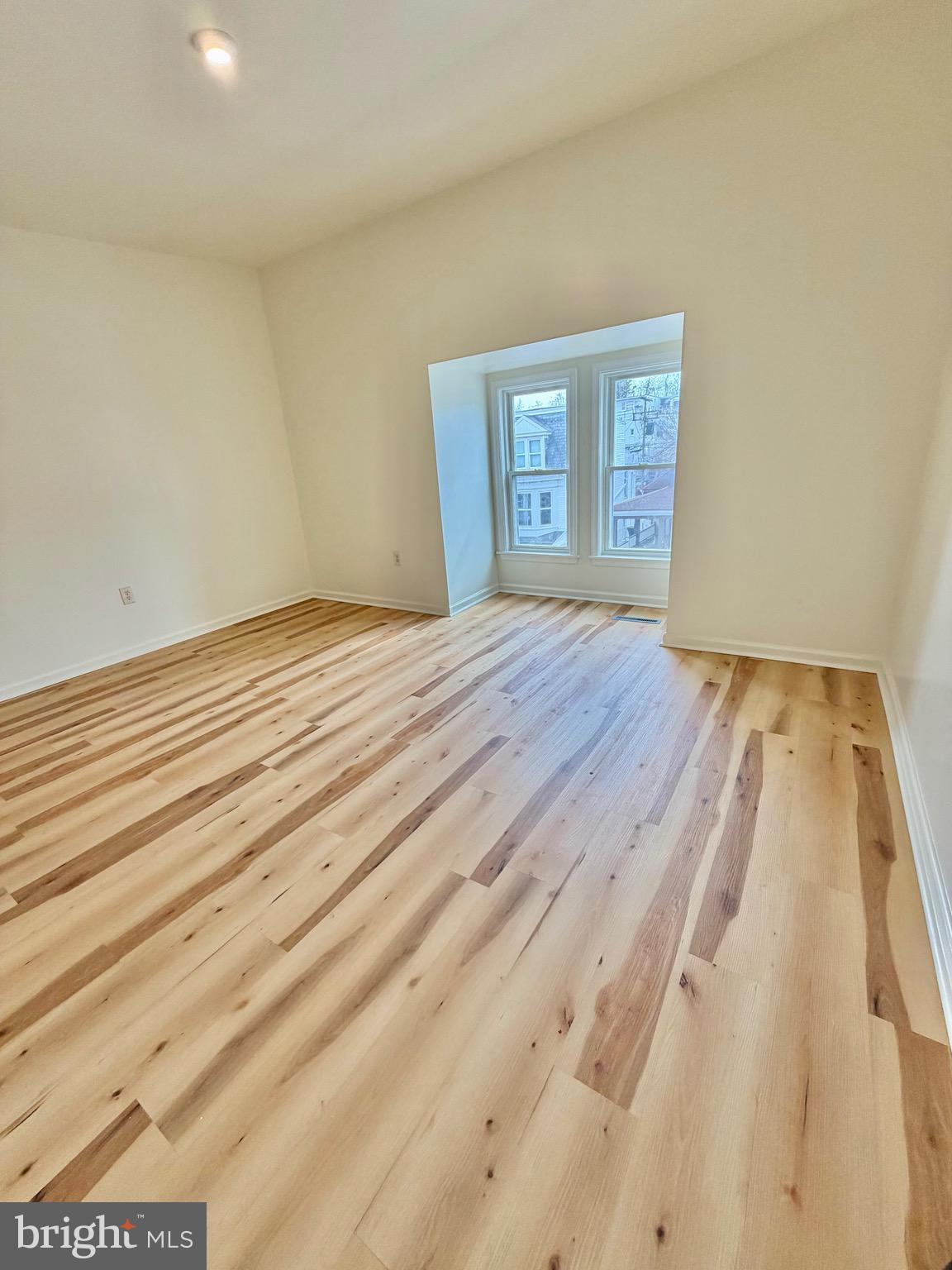 1211 West Poplar Street York, PA 17404 - Photo 34 of 38 a view of an empty room with wooden floor and a window