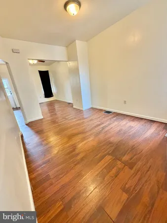 a view of a room with wooden floor