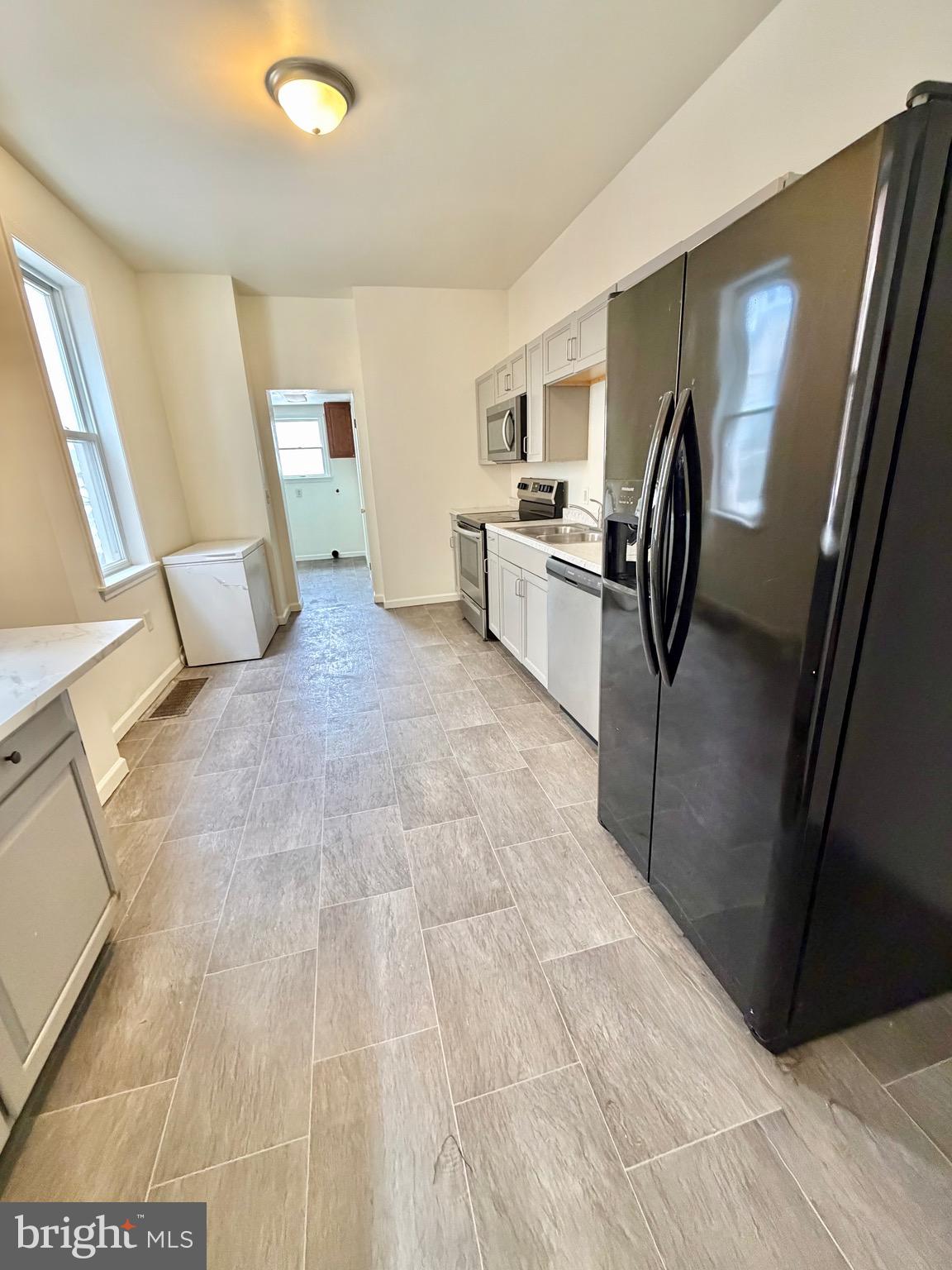 1211 West Poplar Street York, PA 17404 - Photo 10 of 38 a view of a kitchen with furniture and refrigerator