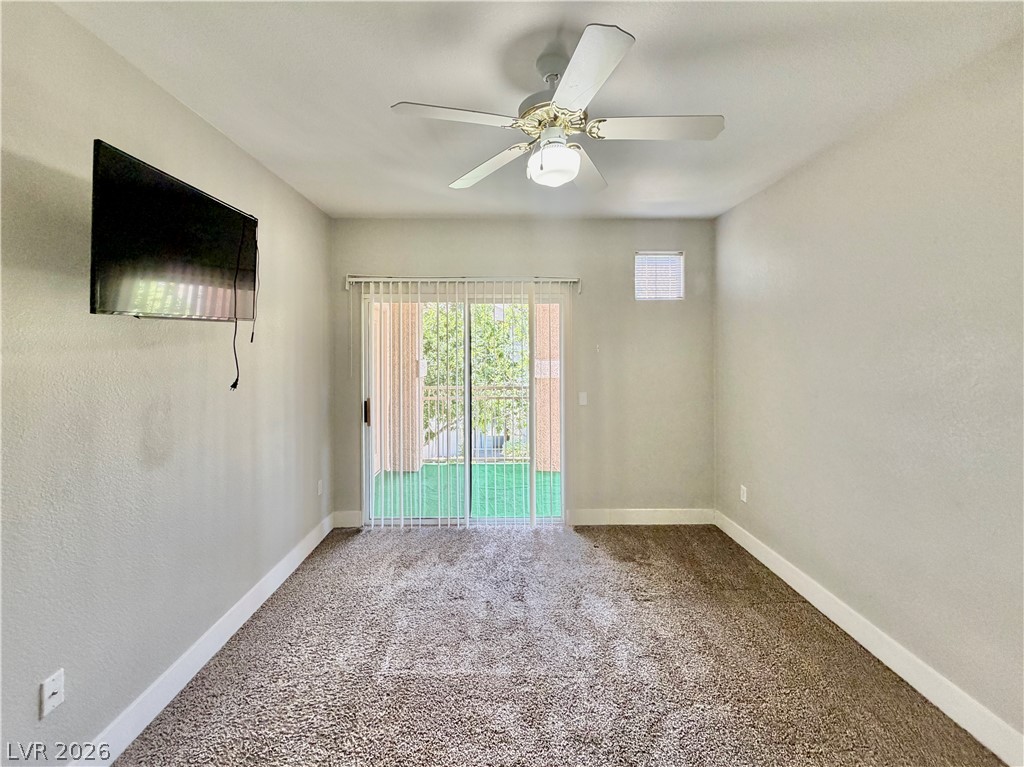 8555 West Russell Road, Unit 2018 Las Vegas, NV 89113 - Photo 15 of 23 An inviting room features a sliding glass door leading to an outdoor space.
