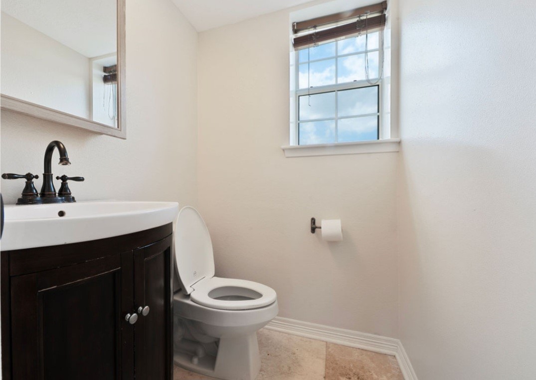 4214 Monitor Street Houston, TX 77093 - Photo 18 of 21 a bathroom with a sink a toilet and window