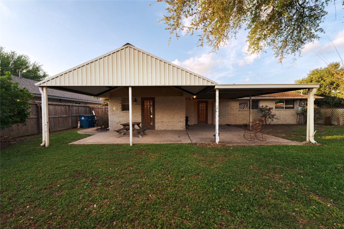 4214 Monitor Street Houston, TX 77093 - Photo 4 of 21 a view of a patio with table and chairs under an umbrella