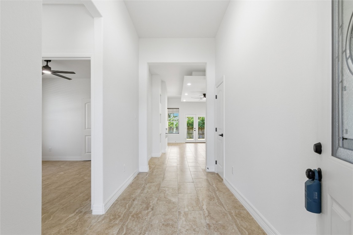214 Manor Avenue Arcola, TX 77583 - Photo 18 of 26 a view of a hallway with wooden floor and a bathroom