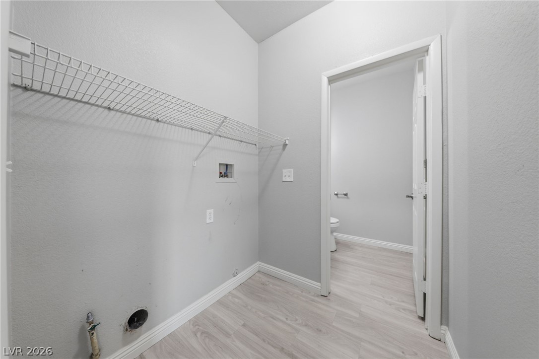 6312 Sandy Ridge Street, Unit 3102 North Las Vegas, NV 89081 - Photo 11 of 31 A dedicated laundry space offers convenience with overhead shelving and hookups for appliances.