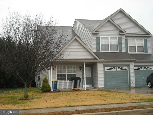 a view of a house with a garden and yard