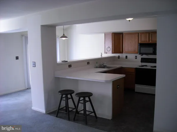 a kitchen with a sink cabinets and window