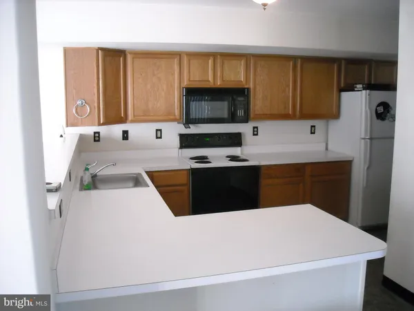 a kitchen with a sink a stove and refrigerator