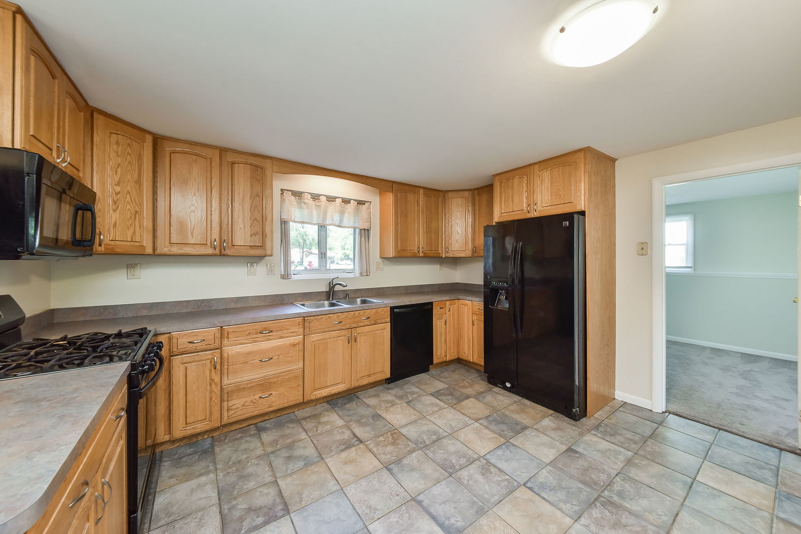 68 Marnel Road Montgomery, IL 60538 - Photo 3 of 15 a kitchen with stainless steel appliances granite countertop a refrigerator and a stove top oven