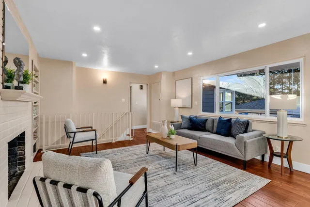 a living room with furniture wooden floor and a fireplace