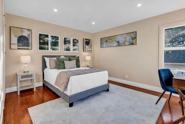 a bed room with a bed and chair