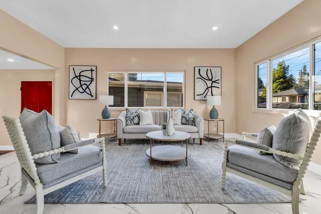 a living room with furniture and a large window