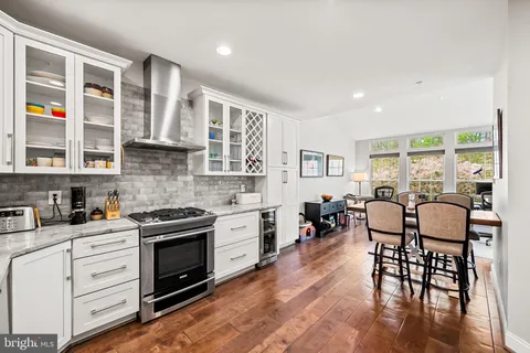 a kitchen with stainless steel appliances granite countertop a stove and cabinets