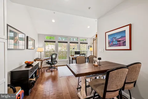 a dining room with furniture and wooden floor